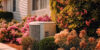 Clean AC unit outside with pink flowers