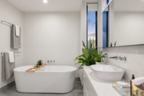 Image shows a bathtub with a single can light above it