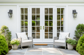 Image of white, double French doors on a patio to inside a home