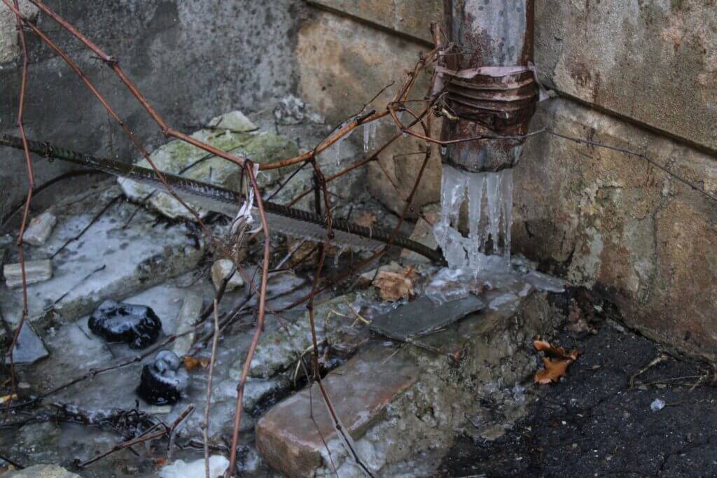 An image of a pipe with ice flowing out of it