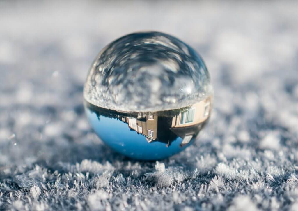 Image of a frozen ball of ice with a home reflected inside
