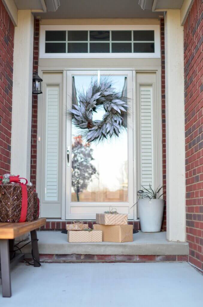Front porch and door with a wreath and wrapped gifts