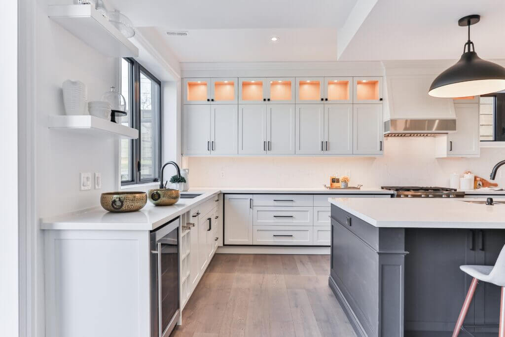 newly refaced white kitchen cabinets with dark hardware in a modern kitchen
