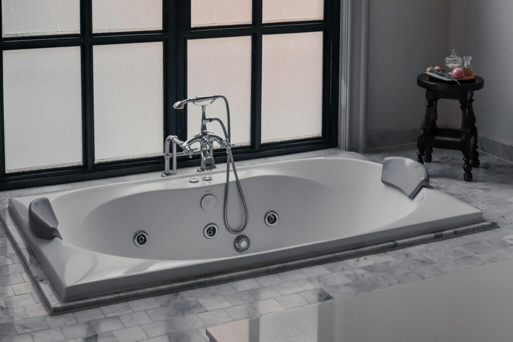 Luxury white marble bathroom with a drop-in jetted tub