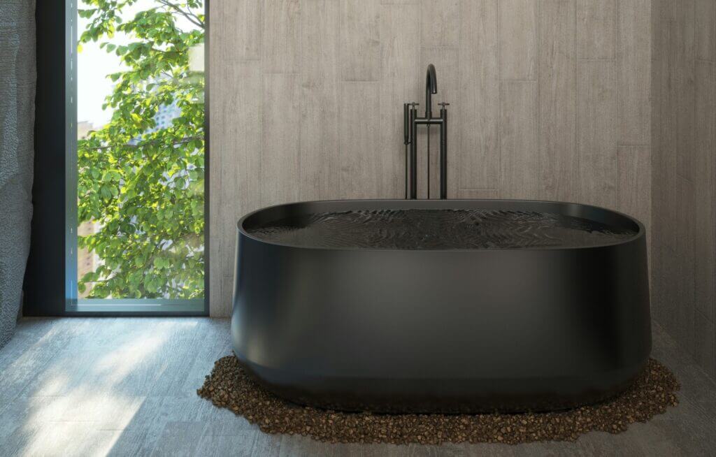 A black bathtub in a modern bathroom