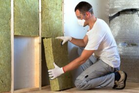 Image of a contractor installing insulation into residential walls