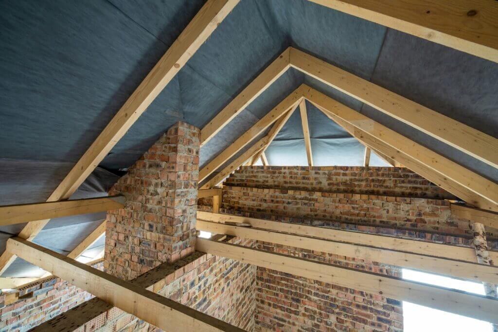 Image of the interior roof of a home covered in insulation