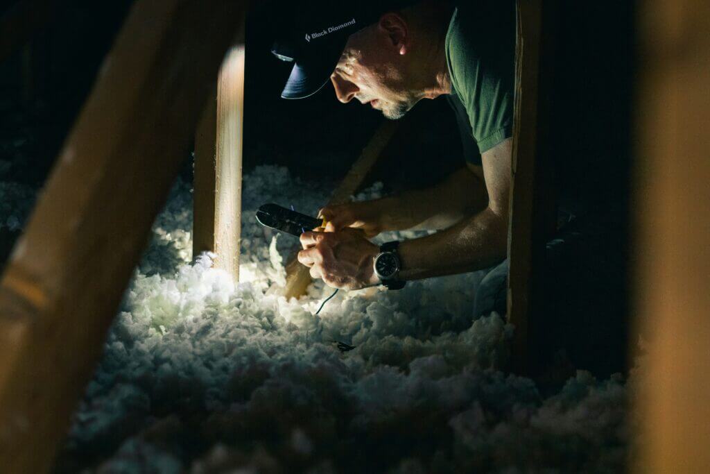 Image of a contractor in an attic filled with blown-in insulation