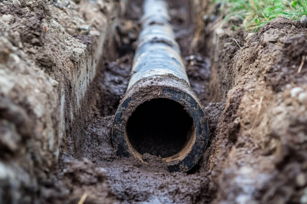 Close-up image of a sewer line facing into the pipe