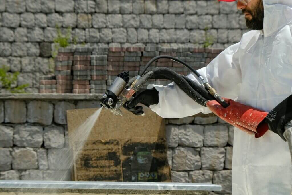 Image of a contractor with a spray gun installing spray foam insulation