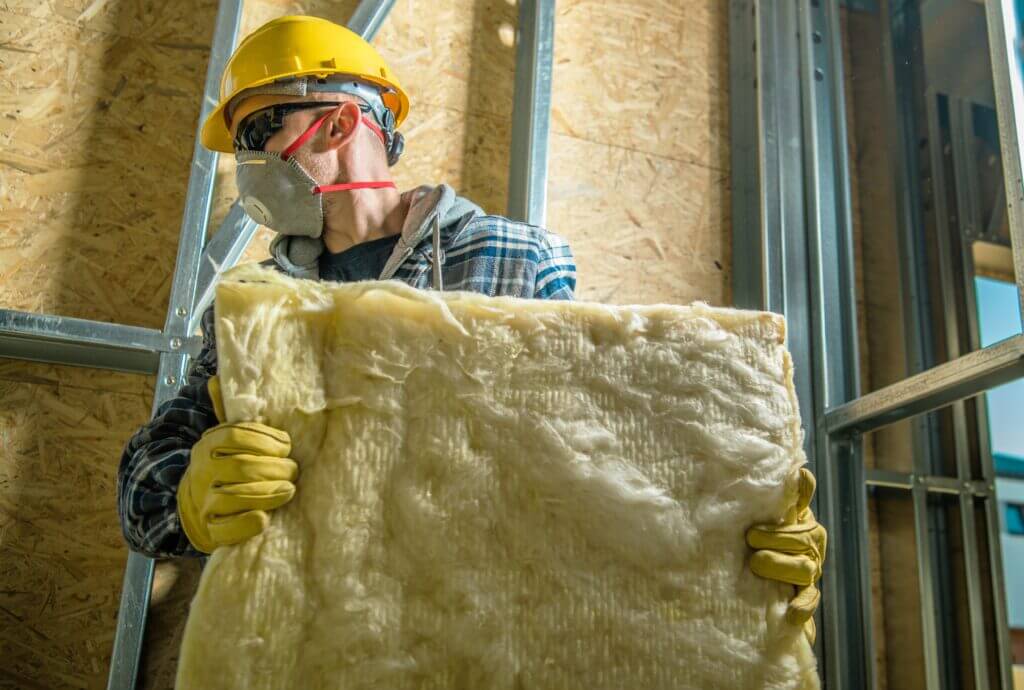 Contractor carrying mineral wool insulation