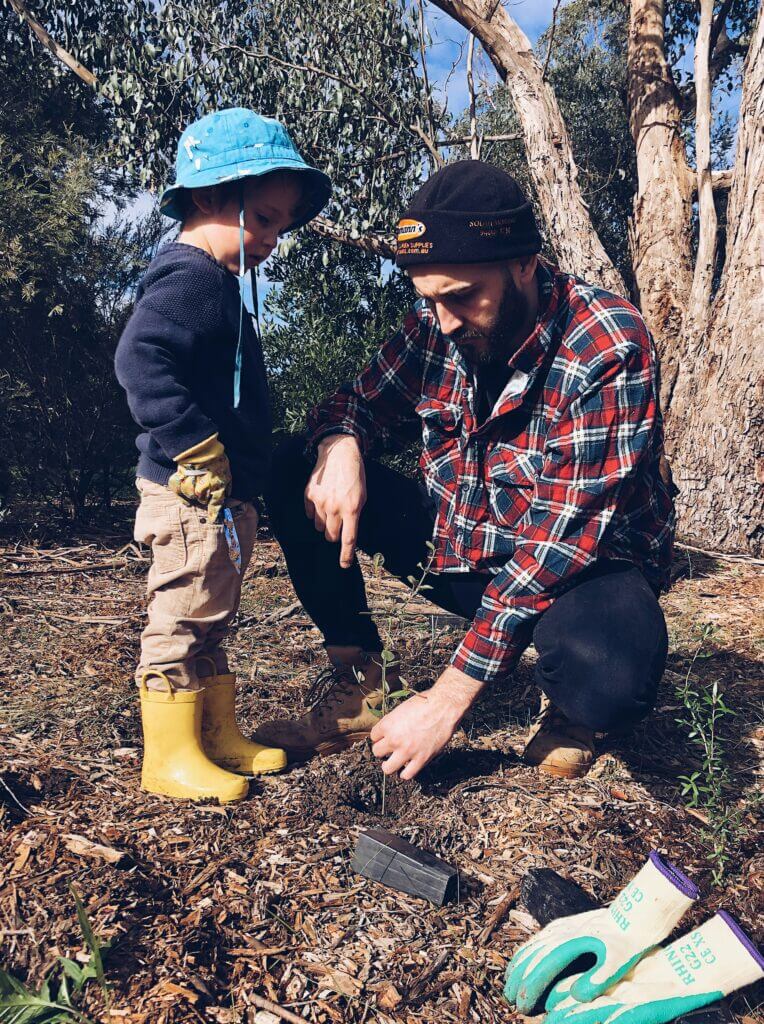 Parent and child planting a tree