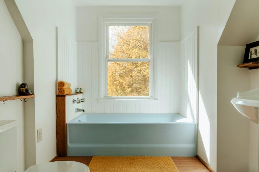 Photo of a blue alcove tub with white tile surround