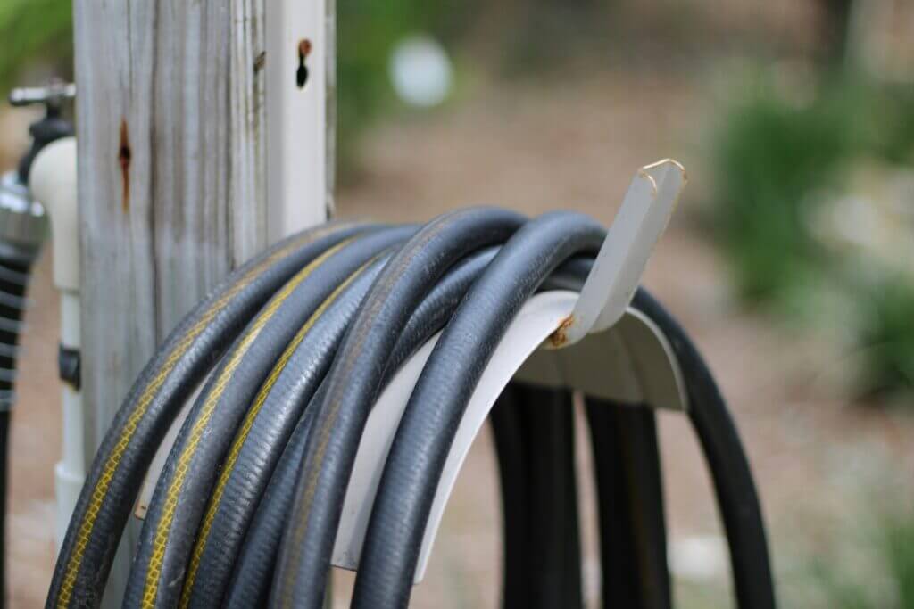 Connected outdoor hose wrapped up on a hanger