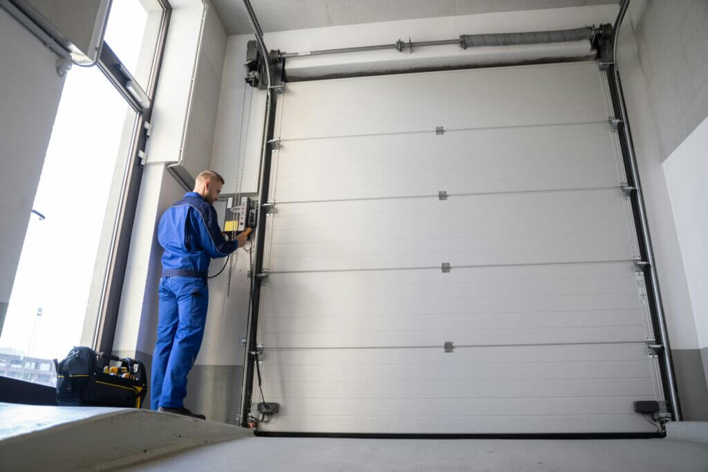 Contractor checking the track stability on a garage door