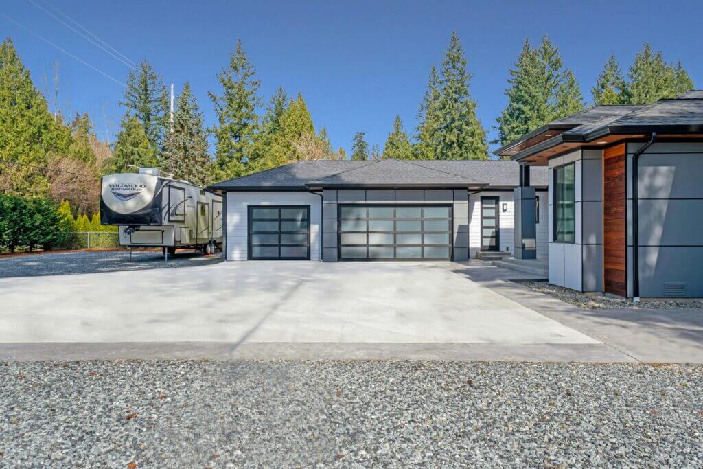 Modern single-story home with 3-car garage with glass panels