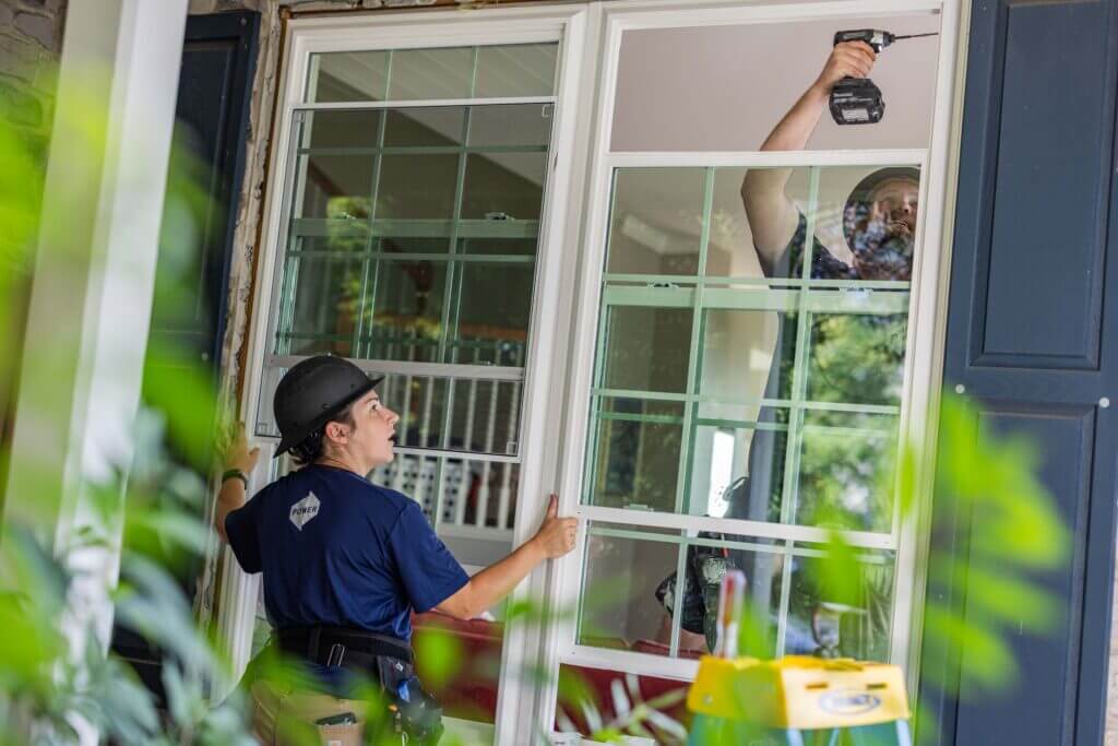 A Power Home Remodeling team installing new windows