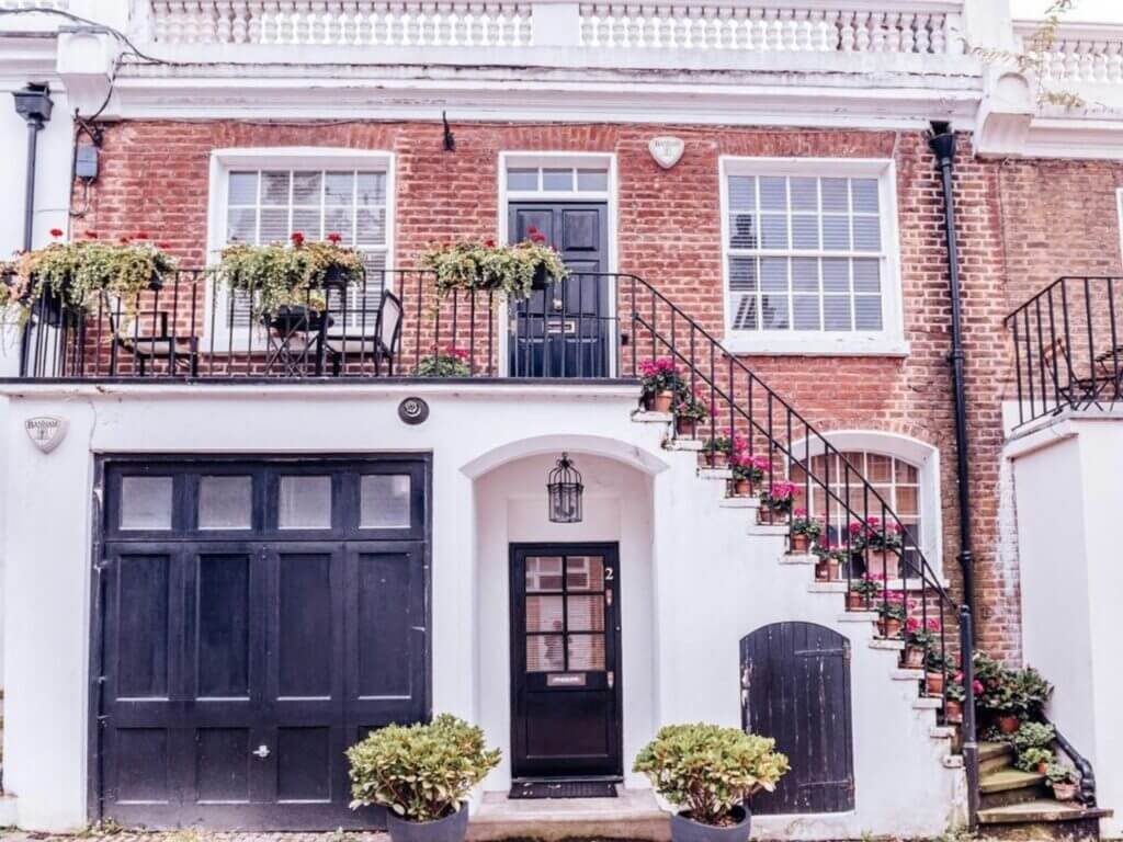 Side-hinged garage door on a brick townhouse