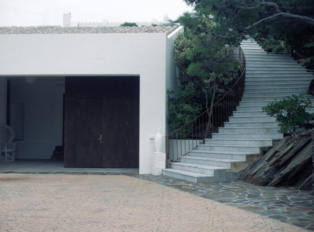 Home with first-level garage doors that slide open