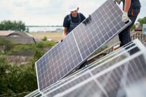 Contractor installing residential solar panels on a roof