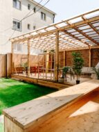 Wood deck with built-in seating and a wooden pergola