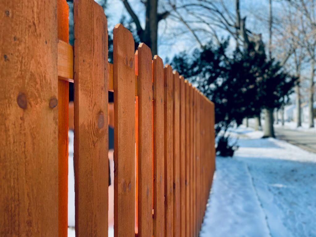Cedar picket fence in winter