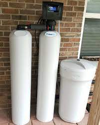 Leaf Home Water Softener installed on a brick exterior