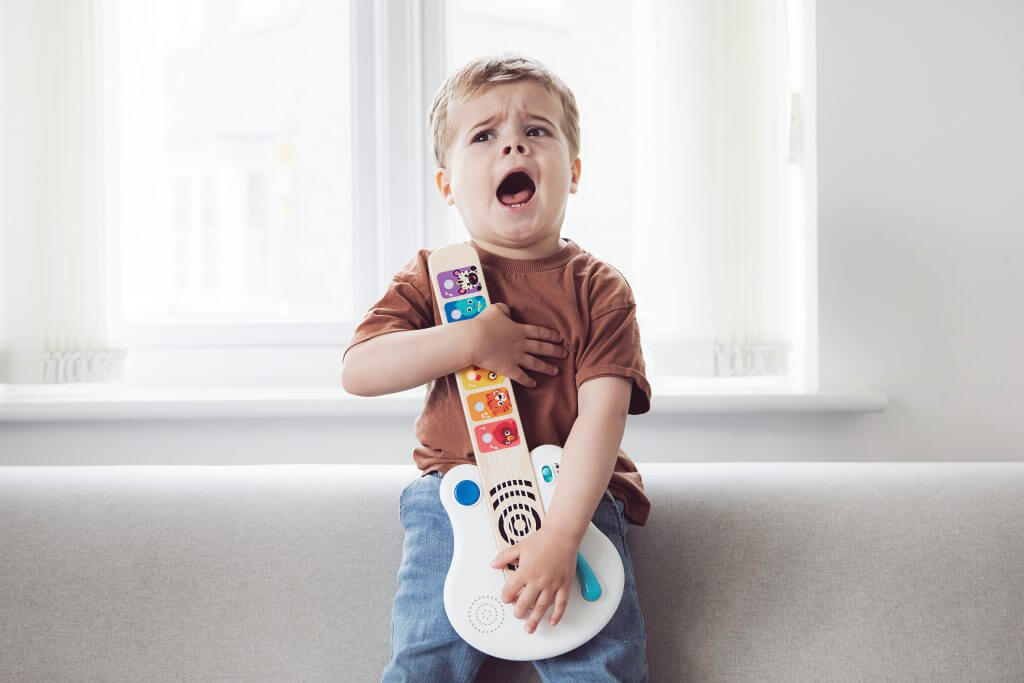 Photo of a child with a toy guitar 