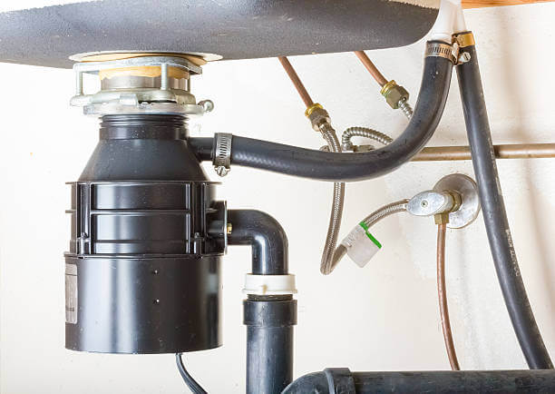 Under the sink garbage disposal unit.