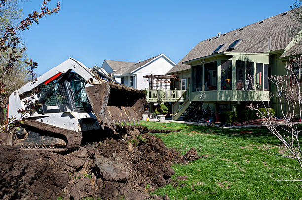 Bulldozer regrading a backyard