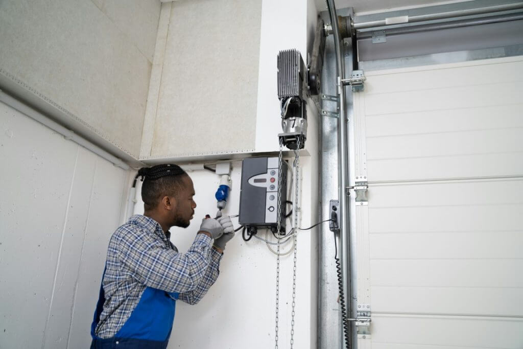 Person repairing a garage door system