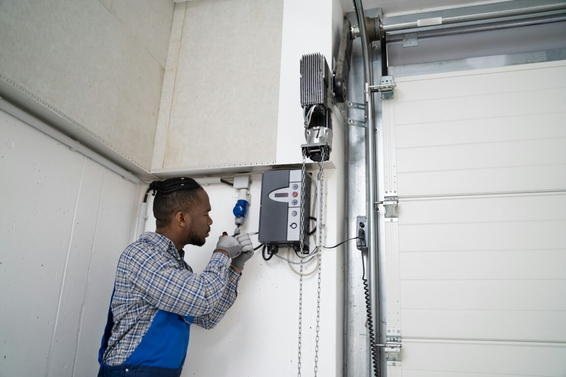 Person repairing a garage door system