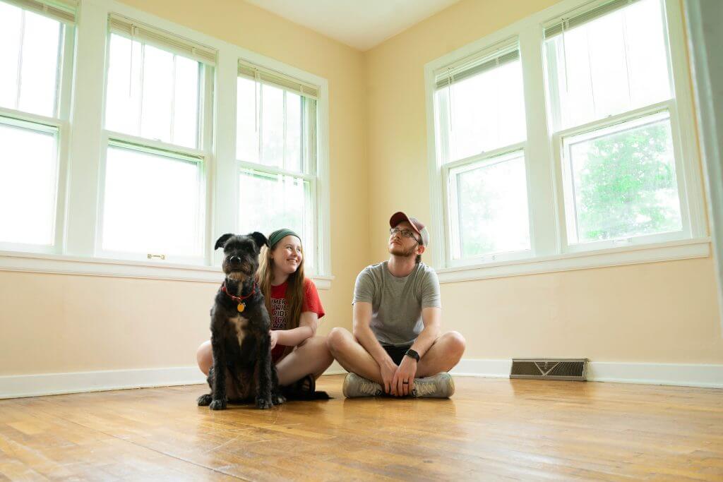 First-time homeowners and dog in new home