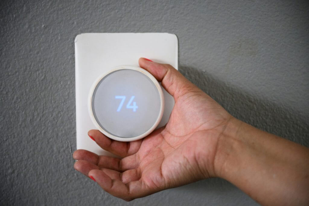 White thermostat set to heat