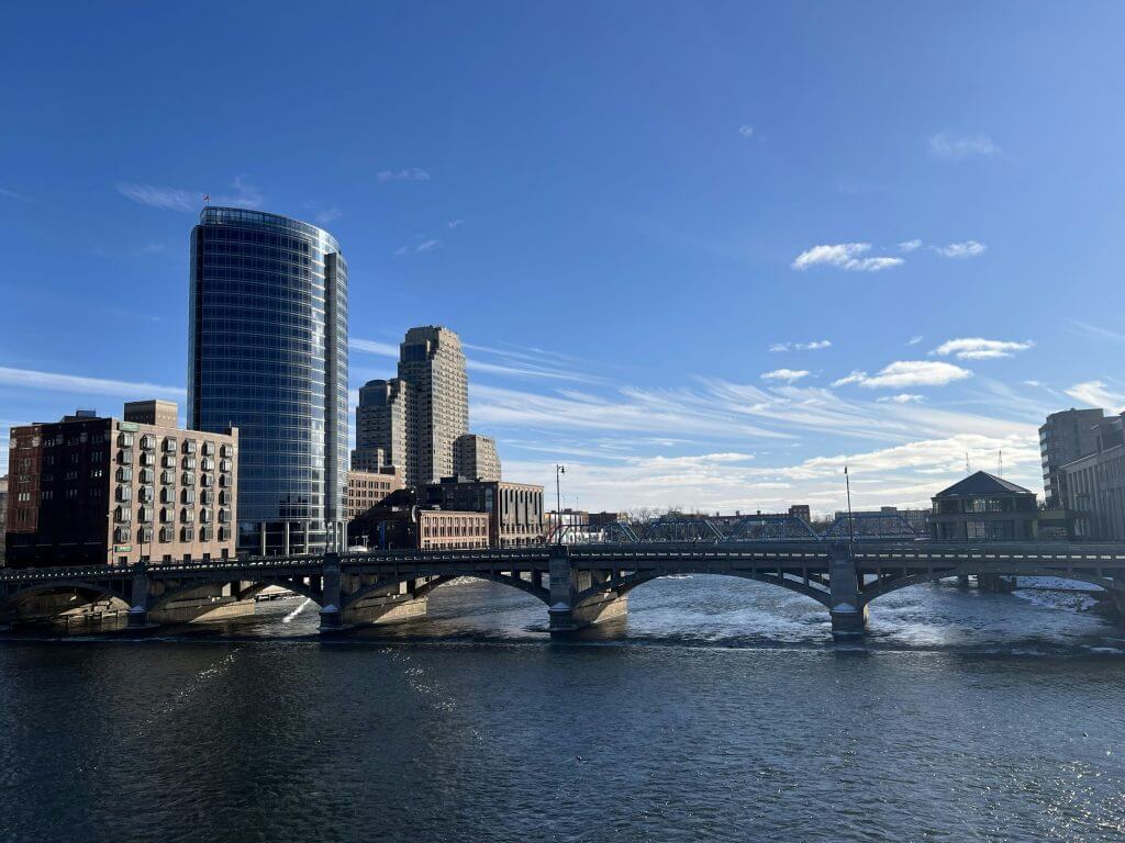 Photo of water, a bridge, and buildings in downtown Grand Rapids, MI