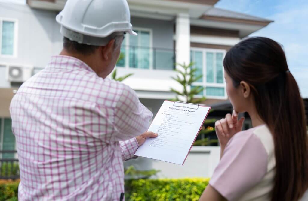 Site inspector discussing findings with homeowner
