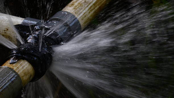 burst pipe with water spraying out