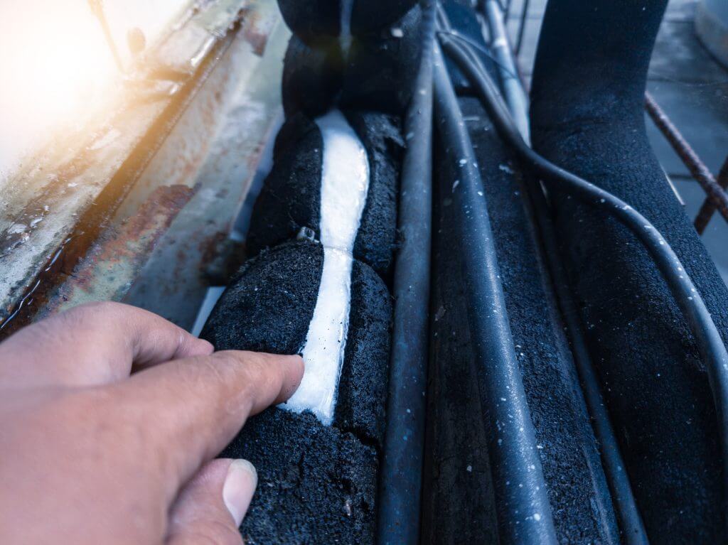 Refrigerant line pipe freezes in HVAC system.