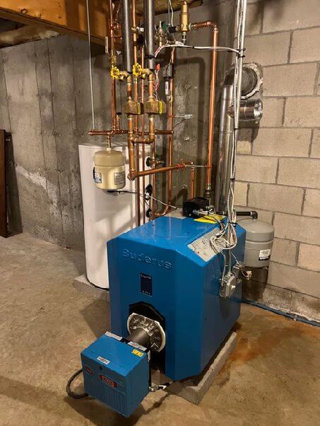 Buderus boiler installed at ground level with copper piping