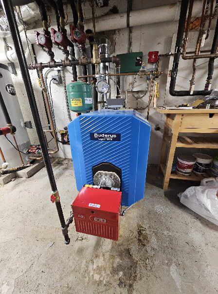 Buderus boiler installed above the ground in a work and machine room