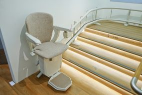 Curved stairlift on lighted stairs