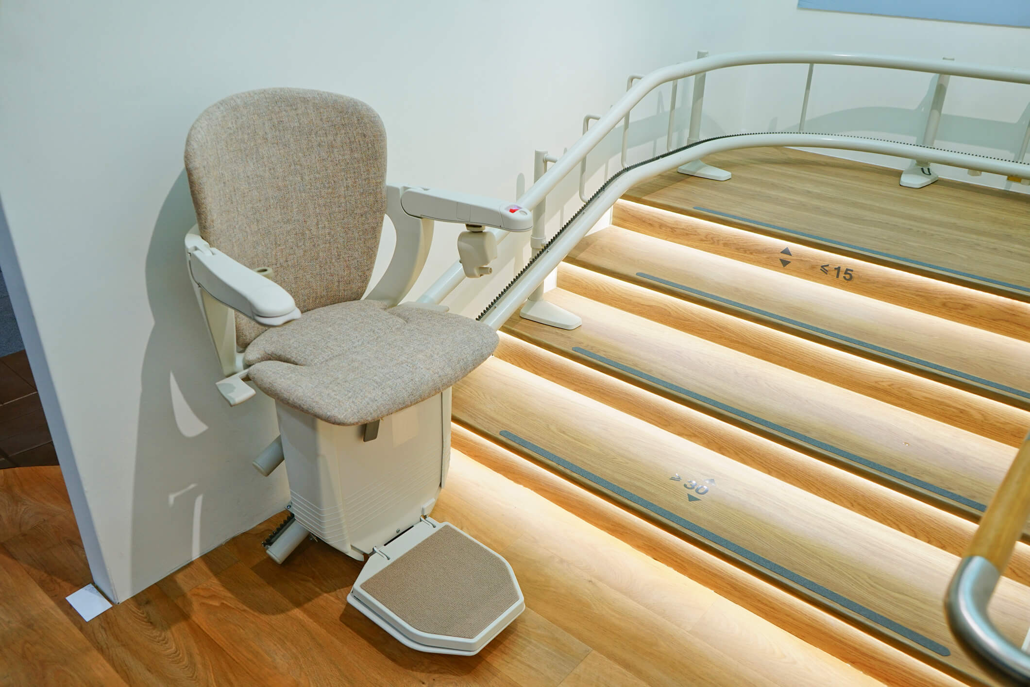 Curved stairlift on lighted stairs