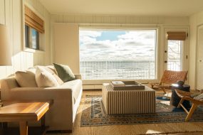 Large home window looking out at a beach view