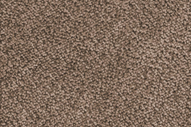 Plain brown colored fabric detail texture. Structure of carpet, upholstery closeup, macro. Wallpaper, backdrop, textile background.