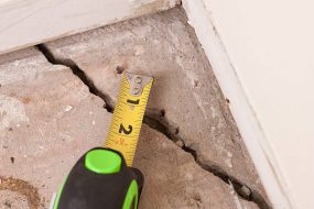 large deep crack in concrete foundation of house