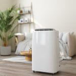 Close-up View Of Portable Air Conditioner With Blurred Living Room Background
