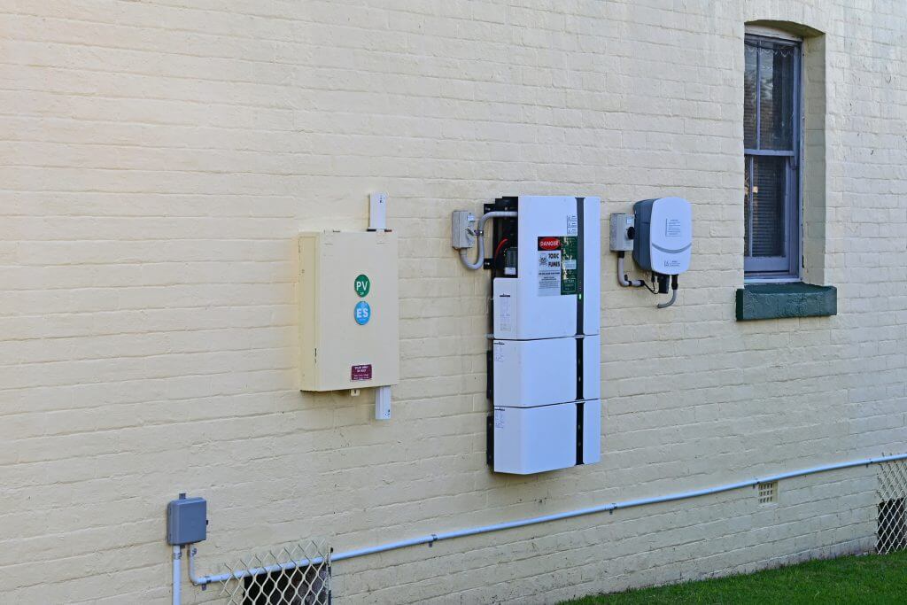 Solar home battery and inverter on a house wall