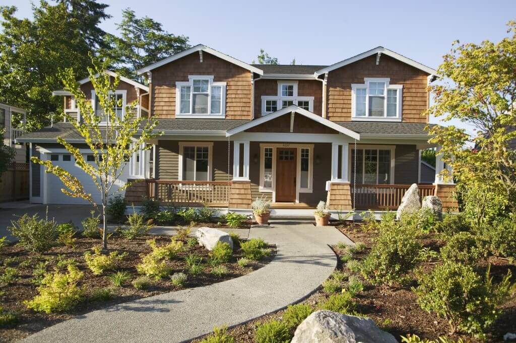 Large, elegant home with wood-look Hardie Shingle siding and upscale landscaping