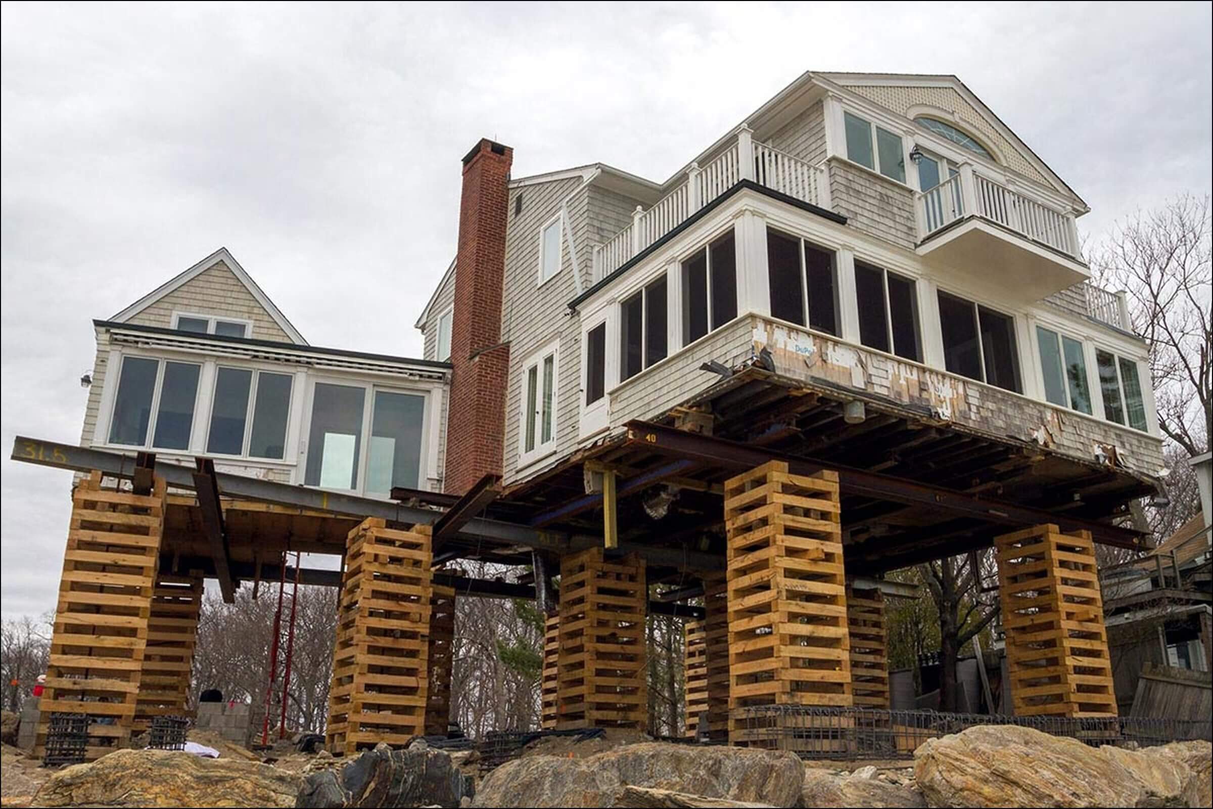 House lifted on wooden stilts to repair or replace the foundation
