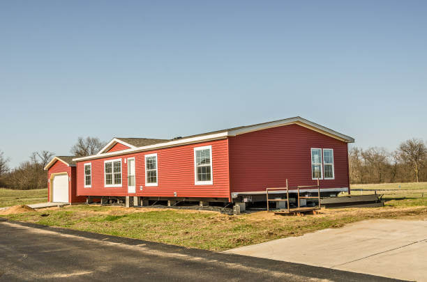 New manufactured home with red vinyl siding and pier and a foundation